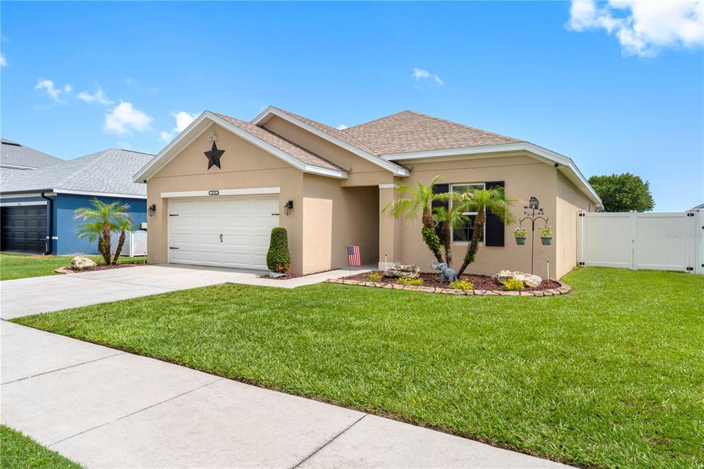An aerial view shows a tan single-story house with a white garage and green lawn — 3518 SAN MOISE PLACE, PLANT CITY, FL