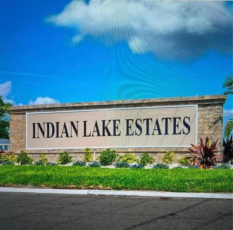 A stone monument sign displays the words Indian Lake Estates against a blue sky — 0 PLUMOSA DRIVE, INDIAN LAKE ESTATES, FL