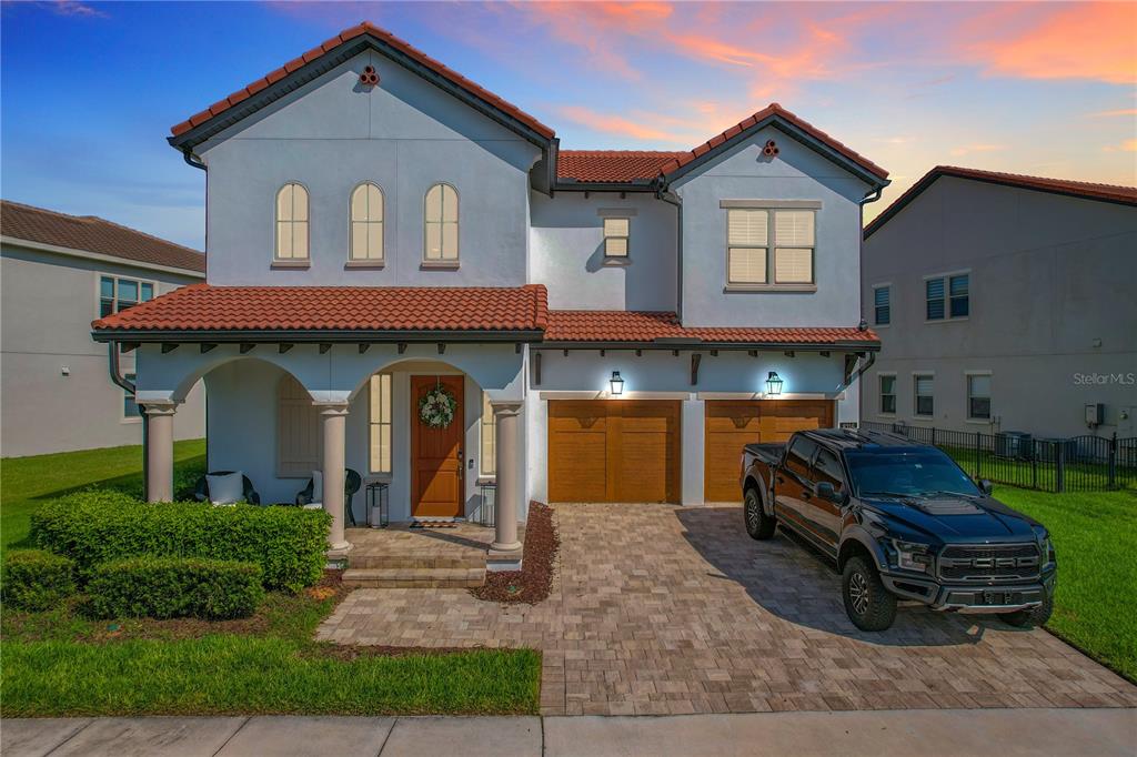 A two-story house with a tiled roof, a two-car garage, and a black pickup truck — 8216 TOPSAIL PLACE, WINTER GARDEN, FL