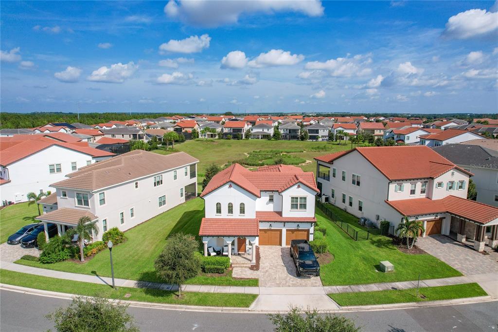 An aerial view shows a two-story suburban house with a tiled roof and paved driveway — 8216 TOPSAIL PLACE, WINTER GARDEN, FL