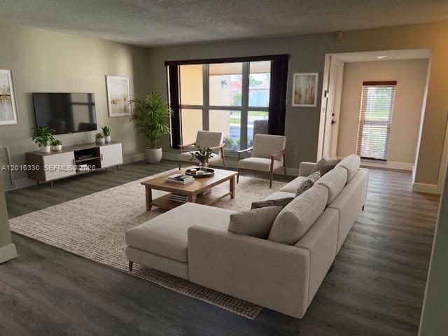 A living room features a sectional sofa, coffee table, two armchairs, and a television console — 10524 NW 4th St, Plantation FL 33324, PLANTATION, FL
