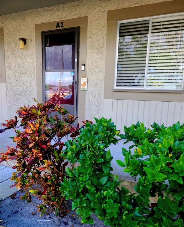 A front exterior view of an apartment unit labeled A2 with a glass door — 6328 NEWTOWN CIRCLE UNIT 28A2, TAMPA, FL