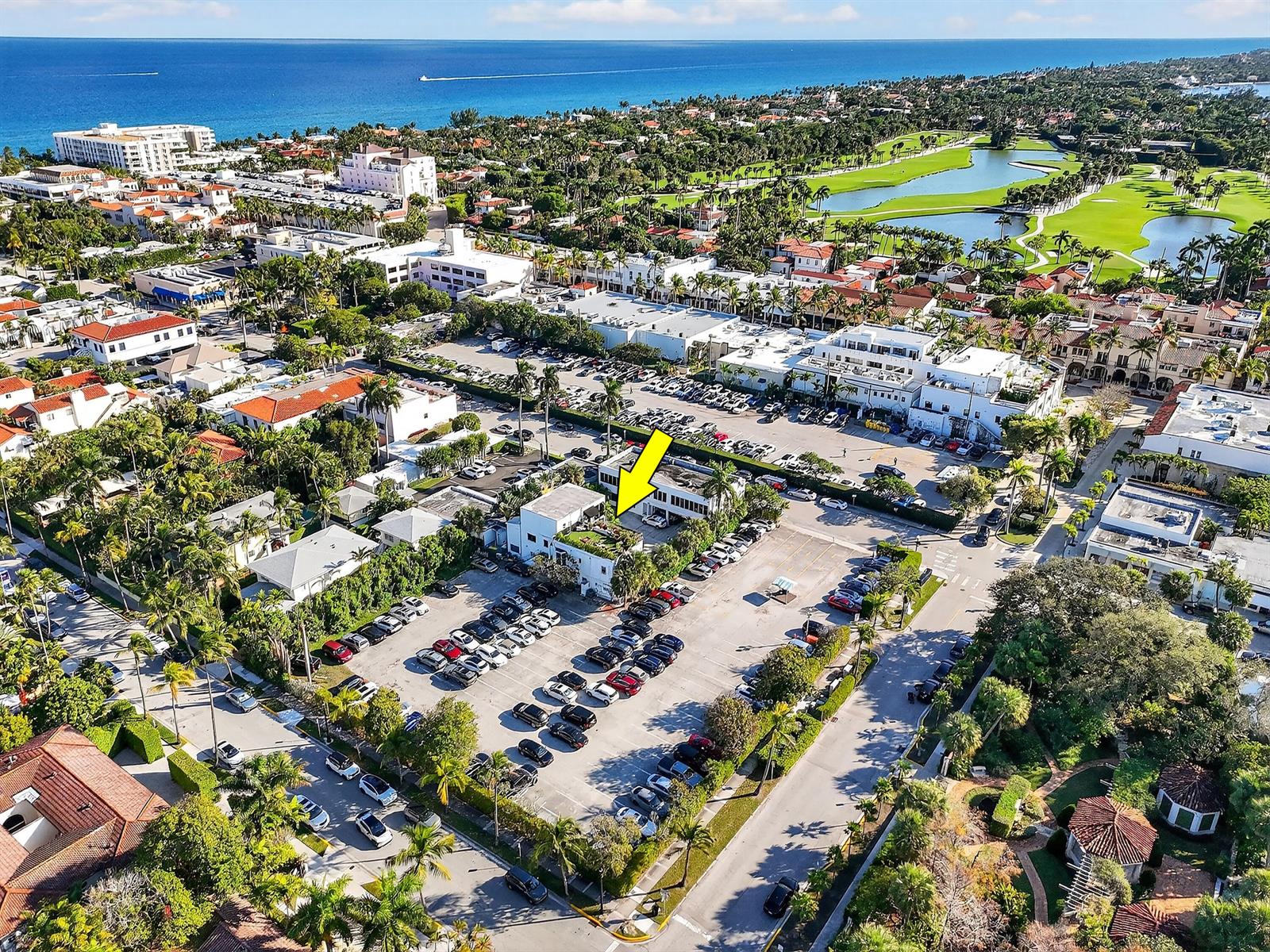 An aerial view shows a commercial building with a rooftop terrace surrounded by parking lots — 249 Peruvian Avenue # 1811, Palm Beach FL 33480, PALM BEACH, FL