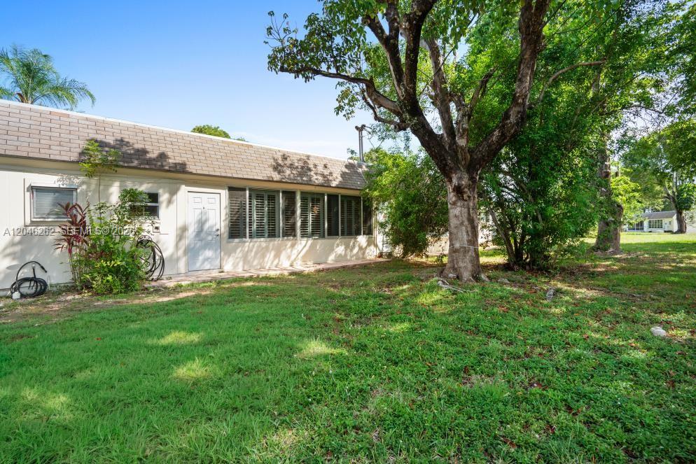 A single-story house exterior features a white wall, a white door, and large windows — 17244 SW 112th Pl # 21342, Miami FL 33157, MIAMI, FL
