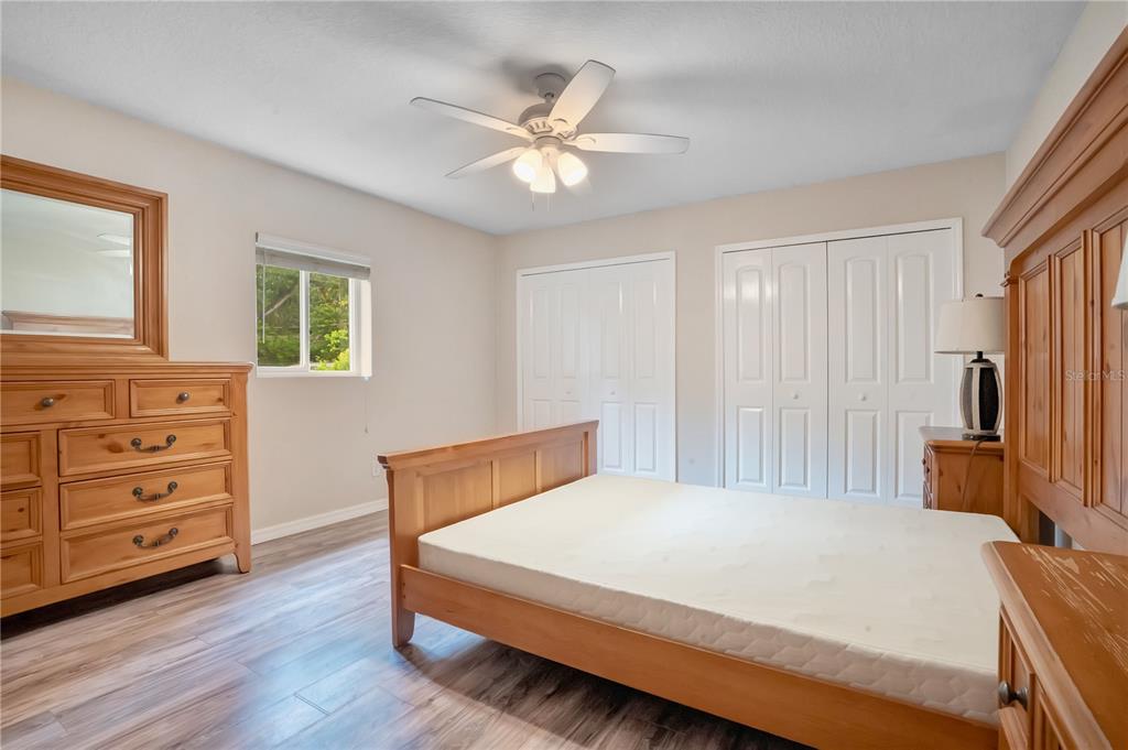 A bathroom features a tiled shower-tub combo, a white toilet, and a dark wood vanity — 4901 BRISTOL COURT, ORLANDO, FL