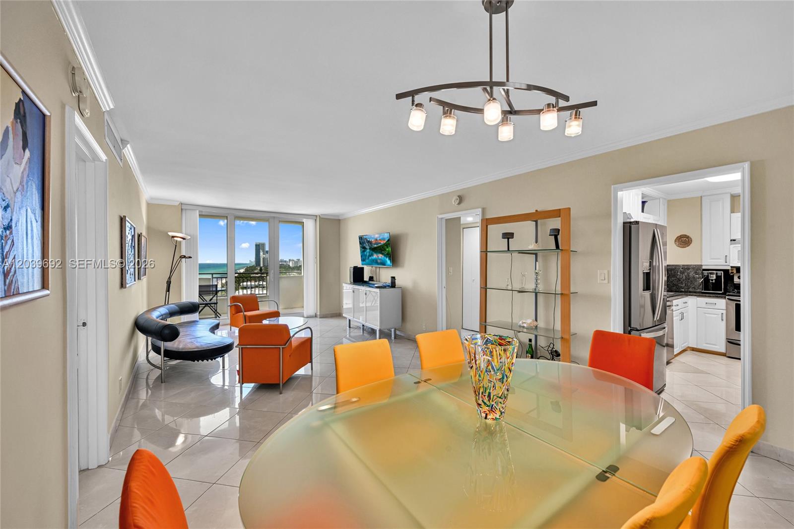 A dining area with a glass table leads into a living room with ocean views — 3180 S Ocean Dr # 1610, Hallandale Beach FL 33009, HALLANDALE BEACH, FL