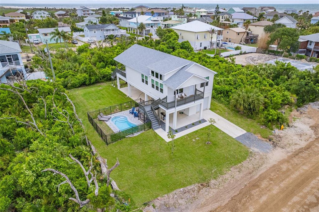 An aerial view of a white two-story house with a pool and fenced backyard — 37 ATLANTIC DRIVE, PALM COAST, FL