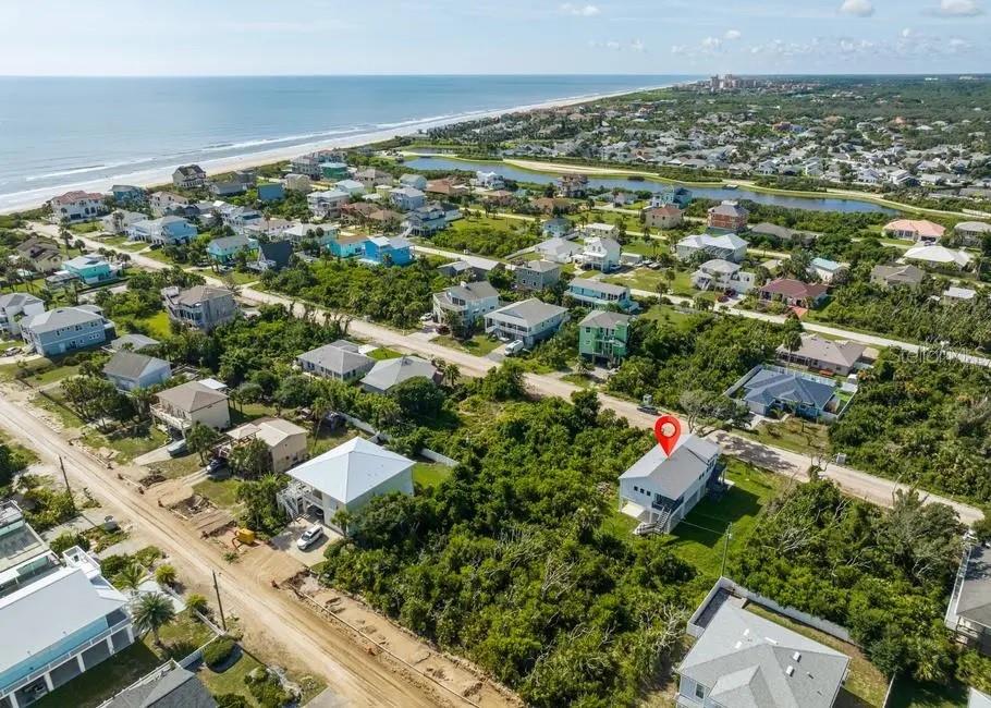 An aerial view shows a coastal neighborhood with a red pin marking a specific house — 37 ATLANTIC DRIVE, PALM COAST, FL