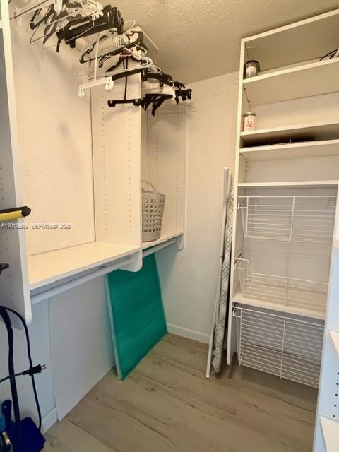 A walk-in closet features white shelving, hanging rods with hangers, and wire storage baskets — 2501 S Ocean Dr # 1627, Hollywood FL 33019, HOLLYWOOD, FL