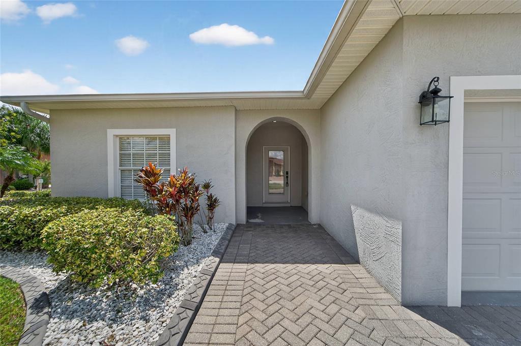 A house exterior features a two-car garage with a standard bay and an extra-tall bay — 453 NOLANE LANE, POLK CITY, FL