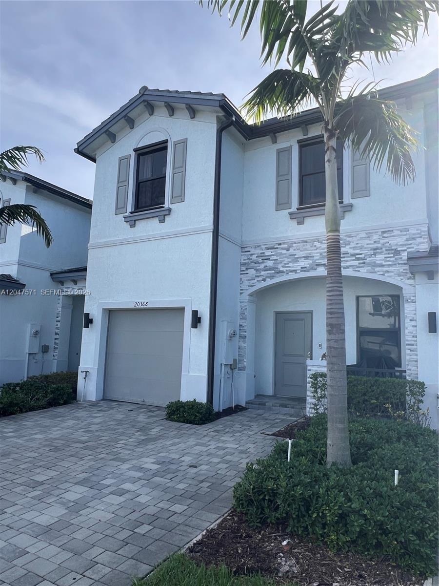 A two-story house exterior with a paved driveway, a garage, and a palm tree — 20368 NW 4th Path, Miami Gardens FL 33169, MIAMI GARDENS, FL
