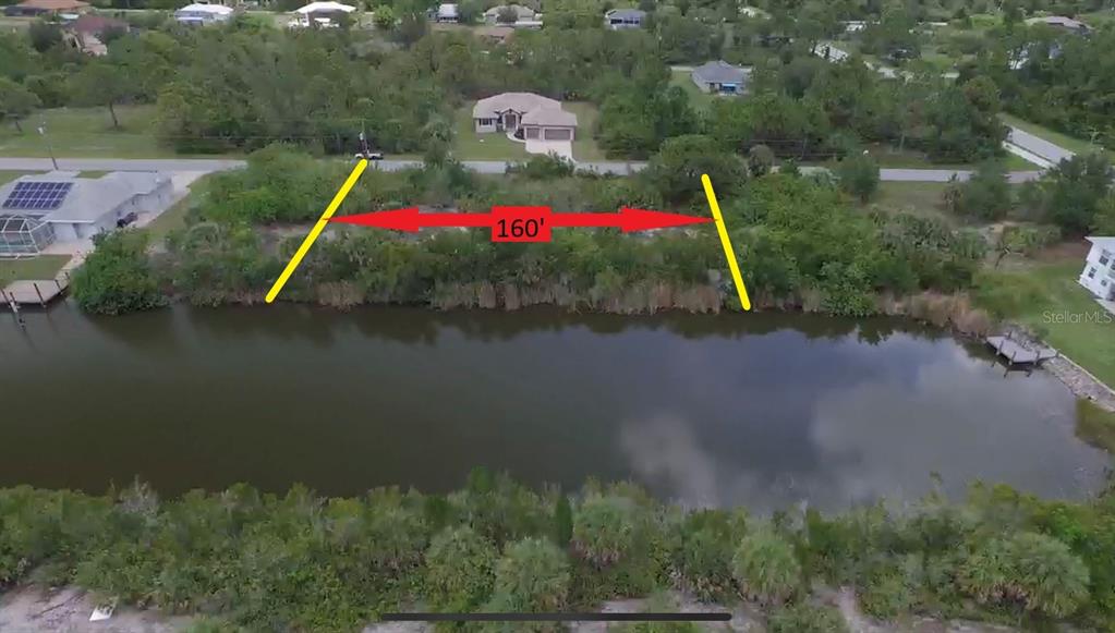 An aerial view shows a vacant, tree-lined waterfront lot marked with a 160-foot measurement — 15536 & 15544 HENNIPEN CIRCLE, PORT CHARLOTTE, FL