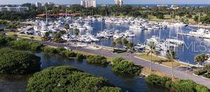 An aerial view of a marina filled with boats next to a road and mangroves — 2600 HARBOURSIDE DRIVE UNIT O-13/14, LONGBOAT KEY, FL