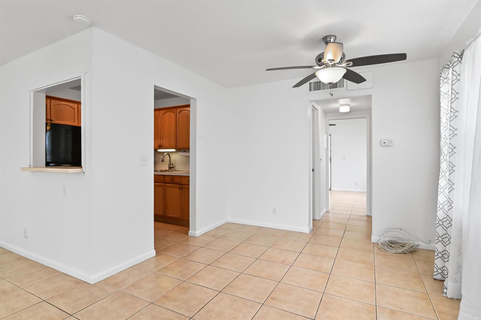 An interior view shows a dining area with tile floors, a ceiling fan, and kitchen access — 149 Coventry # G, West Palm Beach FL 33417, WEST PALM BEACH, FL