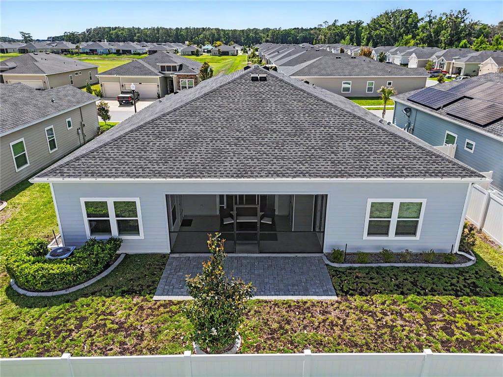 An aerial view of a light blue house with a screened-in patio and backyard — 7369 SW 77TH AVENUE, OCALA, FL