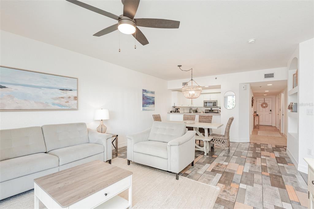 A living and dining area features light-colored furniture, a ceiling fan, and tiled flooring — 5300 S ATLANTIC AVENUE UNIT 14-205, NEW SMYRNA BEACH, FL