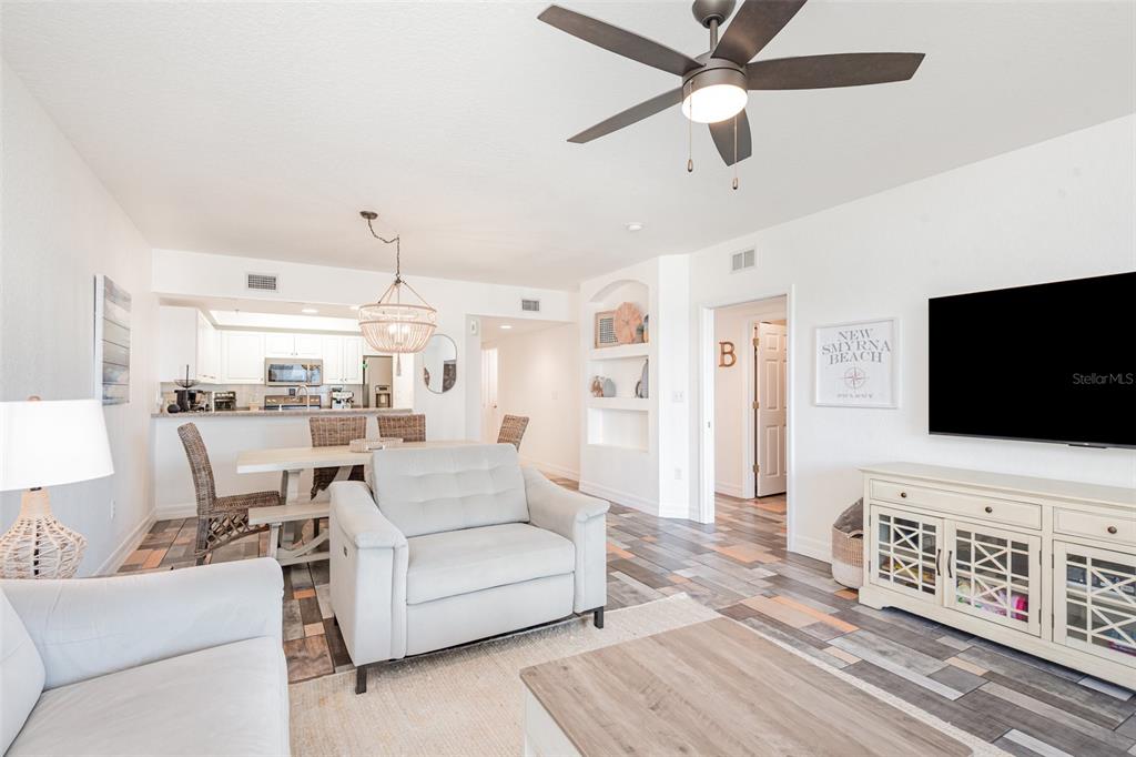 A living room with light-colored furniture, a ceiling fan, and wood-look tile flooring — 5300 S ATLANTIC AVENUE UNIT 14-205, NEW SMYRNA BEACH, FL