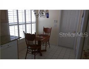 A room with light-colored tile flooring, a ceiling fan, and two white interior doors — 13109 ELGAR PLACE, RIVERVIEW, FL