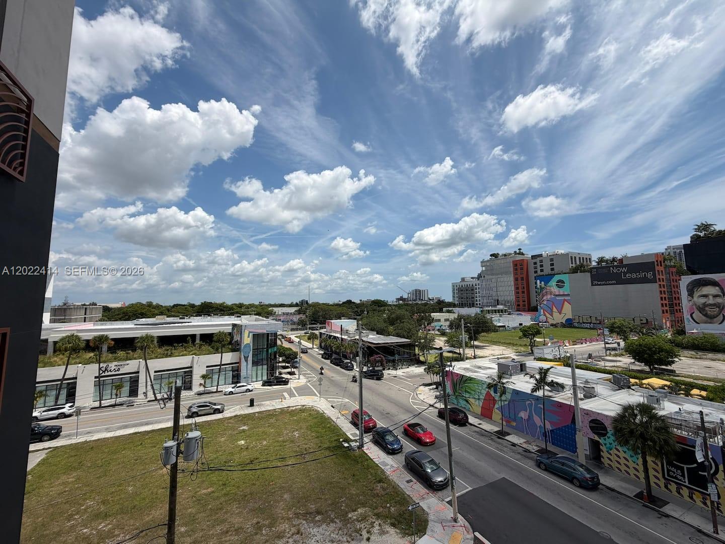 An elevated view of a city street intersection with surrounding buildings, murals, and parked cars — 2700 NW 2nd Ave # 424, Miami FL 33127, MIAMI, FL