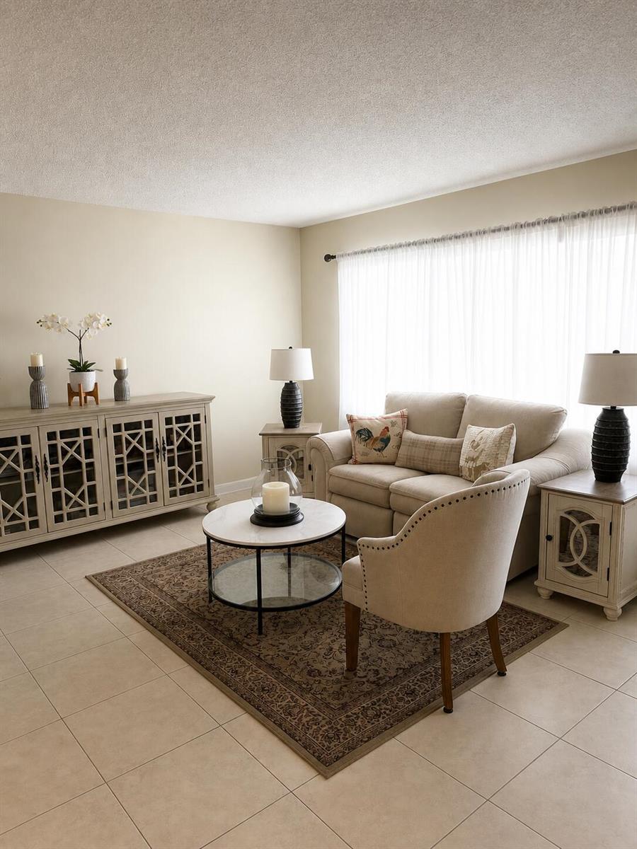 A living room features a beige sofa, an armchair, a coffee table, and a sideboard — 3067 Yarmouth D, Boca Raton FL 33434, BOCA RATON, FL