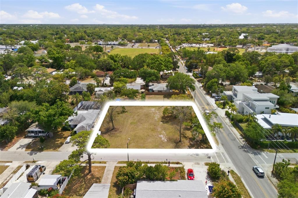 An aerial view shows a vacant, rectangular lot highlighted by a white border — 0 BAY STREET, SARASOTA, FL
