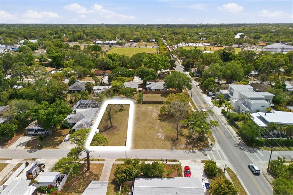 An aerial view shows a vacant, rectangular residential lot highlighted by a white border — 0 BAY STREET, SARASOTA, FL