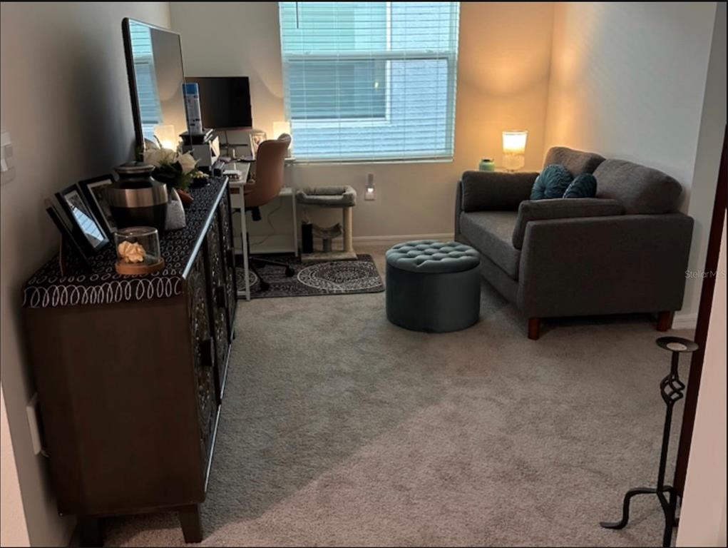 A room with a desk, a gray loveseat, a tufted ottoman, and a dark wood cabinet — 388 MANGROVE SHADE CIRCLE, APOLLO BEACH, FL
