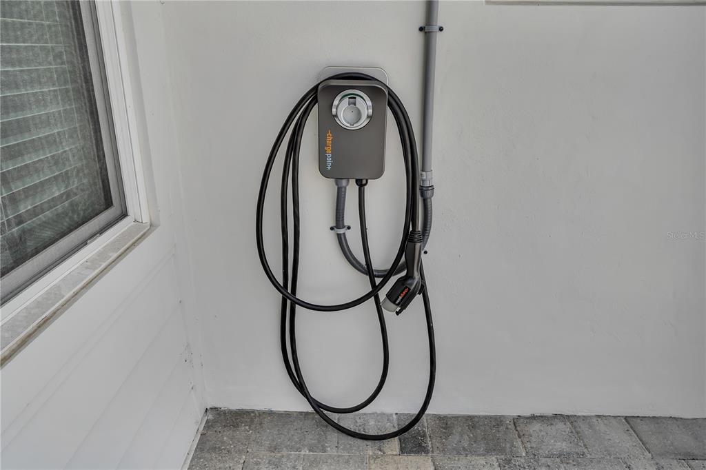 A wall-mounted ChargePoint electric vehicle charging station is installed on an exterior wall — 3295 57TH STREET N, ST PETERSBURG, FL