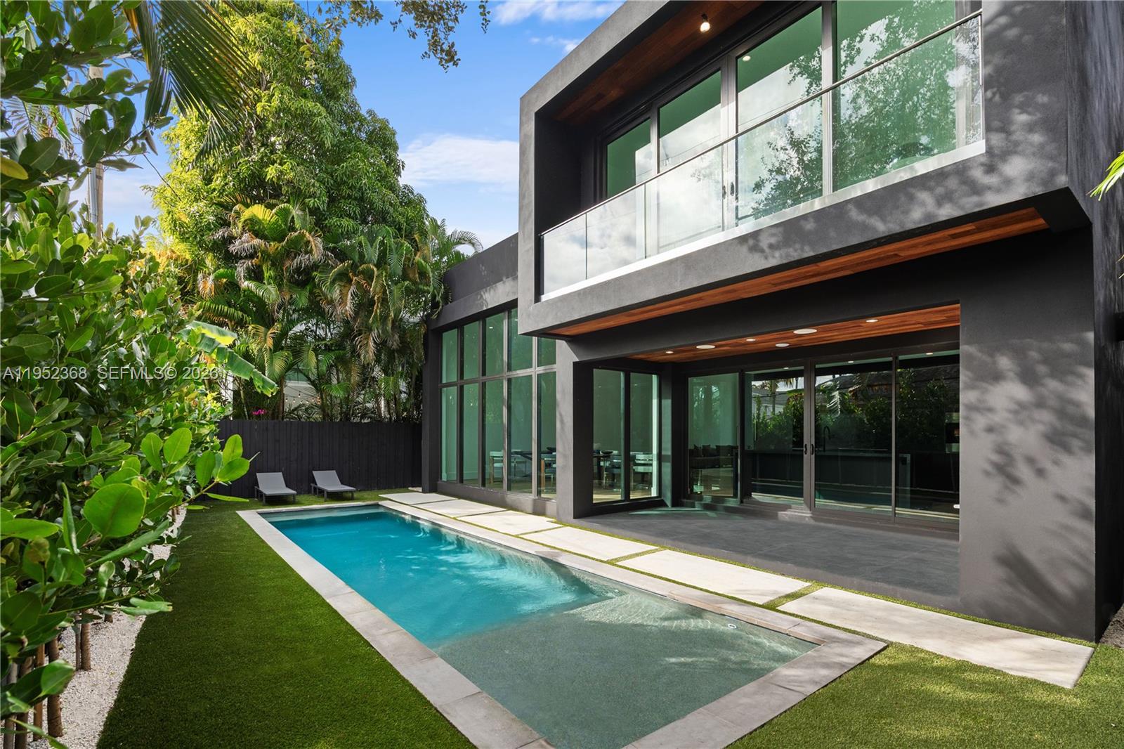A modern two-story house with a rectangular swimming pool and artificial turf backyard — 30 NE 50th St, Miami FL 33137, MIAMI, FL