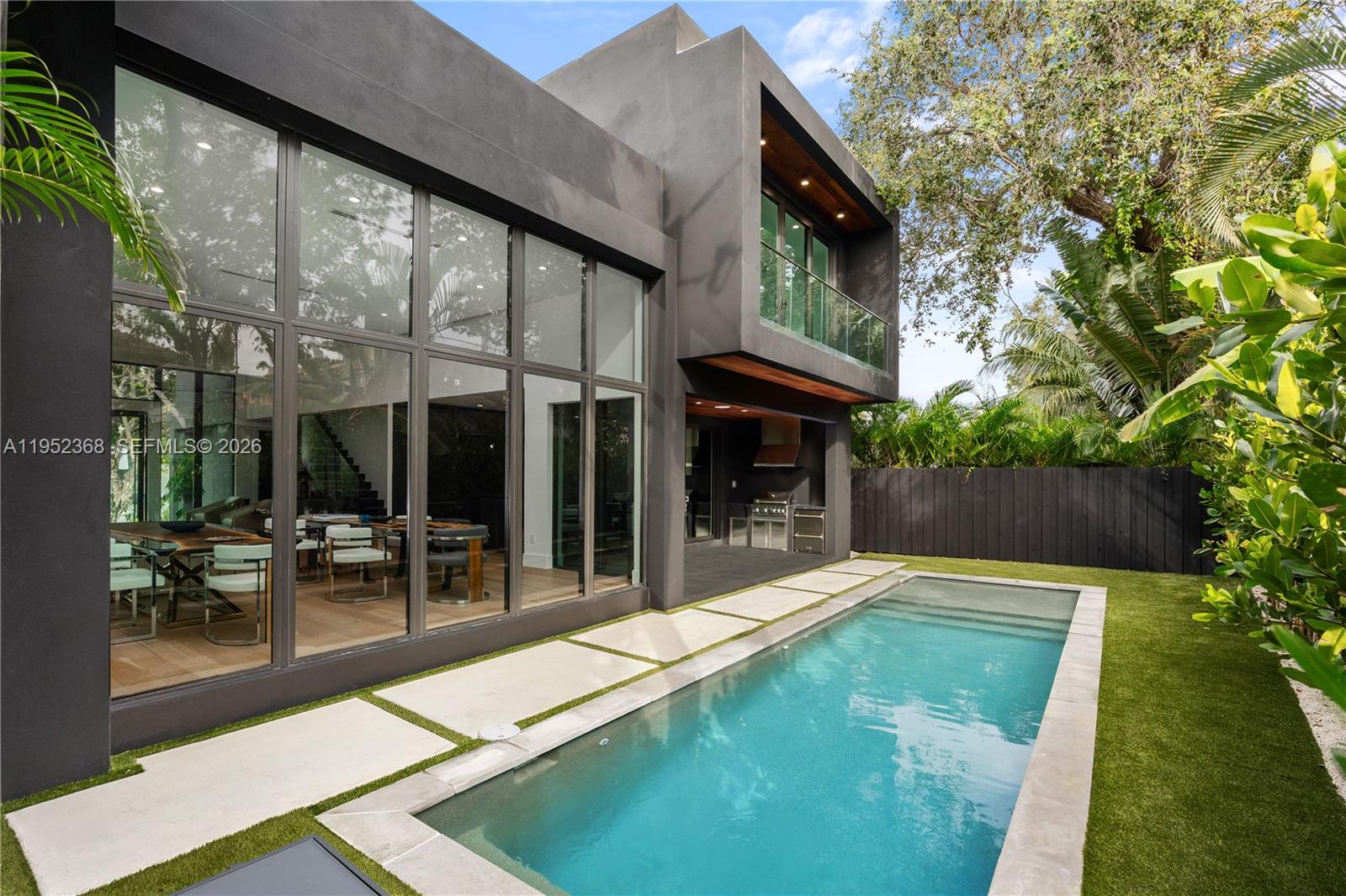 A modern two-story house with a swimming pool, patio, and large glass windows — 30 NE 50th St, Miami FL 33137, MIAMI, FL