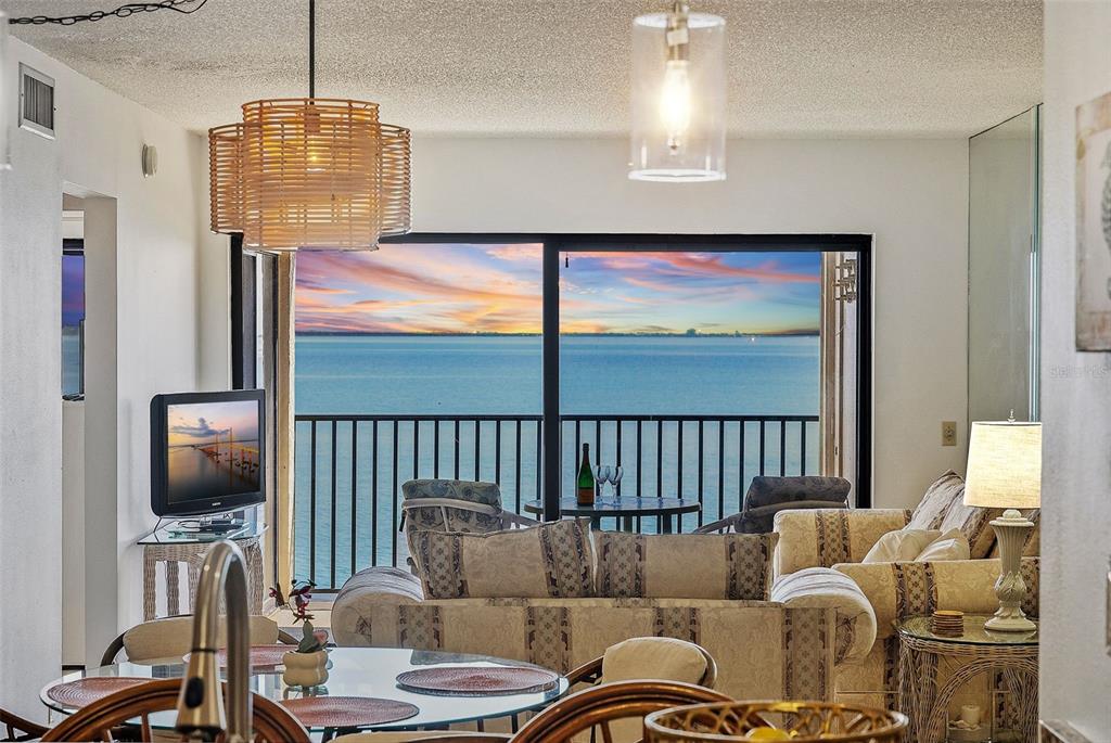 A white front door with a storm door is located in a covered entryway — 6322 PALMA DEL MAR BOULEVARD S UNIT 209, ST PETERSBURG, FL