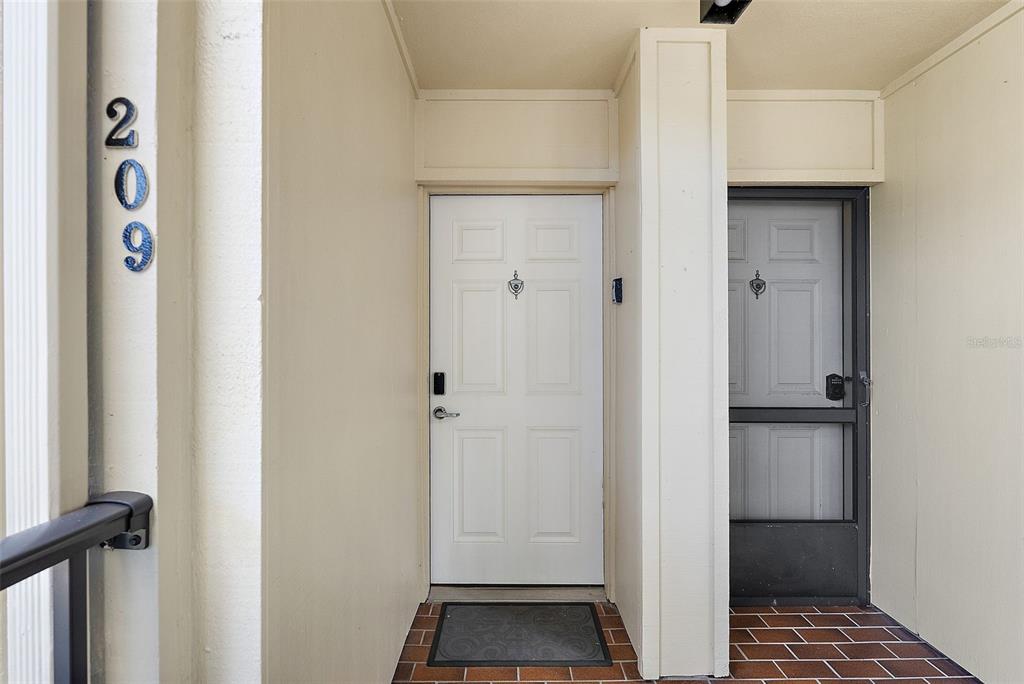 A kitchen features light wood cabinets, granite countertops, stainless steel appliances, and a ceiling fan — 6322 PALMA DEL MAR BOULEVARD S UNIT 209, ST PETERSBURG, FL