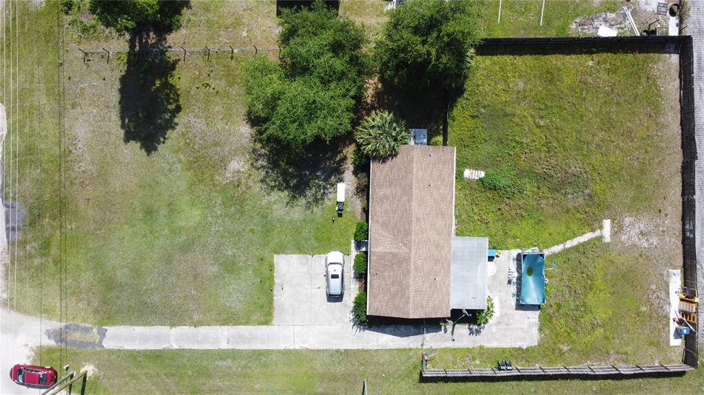 An aerial view shows a house with a driveway, a pool, and a large yard — 6590 OSCEOLA POLK LINE ROAD, DAVENPORT, FL