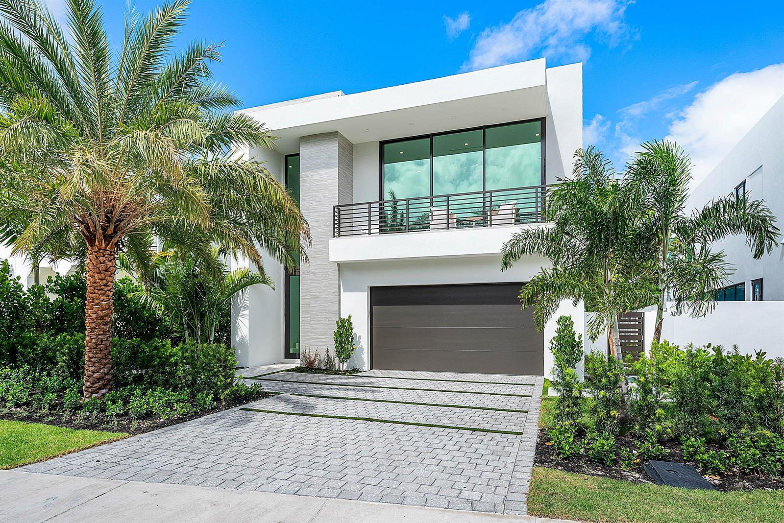 A modern two-story white house with a paved driveway, balcony, and palm trees — 721 Lake Avenue N, Delray Beach FL 33483, DELRAY BEACH, FL