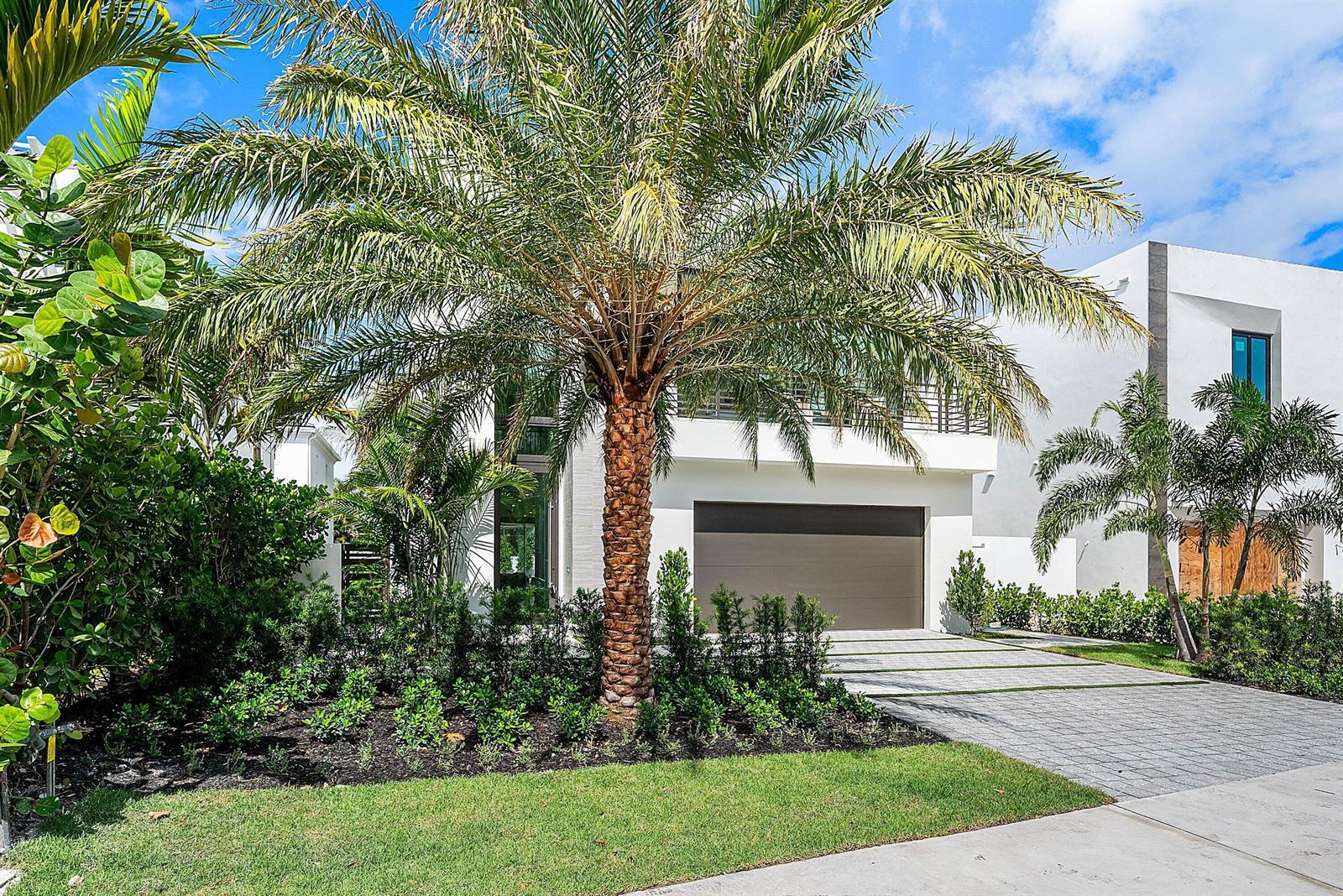 A modern white two-story house features a large palm tree and a paved driveway — 721 Lake Avenue N, Delray Beach FL 33483, DELRAY BEACH, FL