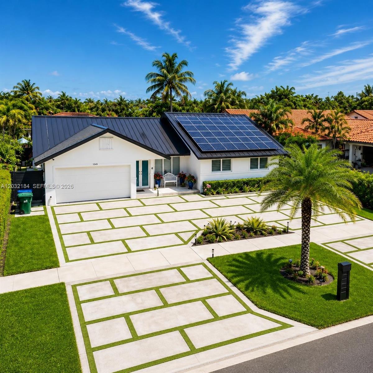 A single-story house with a metal roof, solar panels, and a modern paver driveway — 12440 SW 96th St, Miami FL 33186, MIAMI, FL