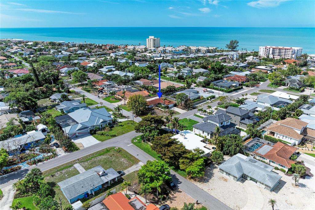 An aerial view shows a residential neighborhood near the ocean with a blue arrow pointing down — 507 GULF STREET, VENICE, FL
