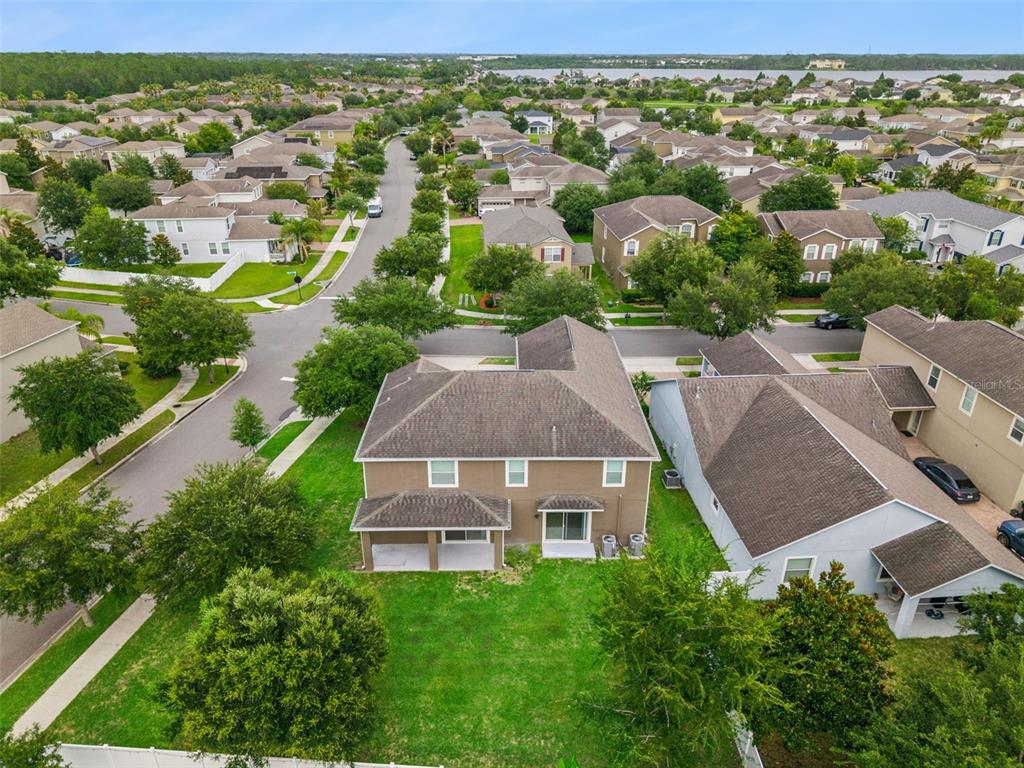 An aerial view shows a two-story house with a backyard and surrounding suburban neighborhood — 6100 CYPRESS HILL ROAD, WINTER GARDEN, FL