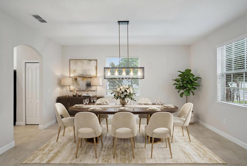 A dining room features an oval table, six upholstered chairs, a chandelier, and a sideboard — 6100 CYPRESS HILL ROAD, WINTER GARDEN, FL