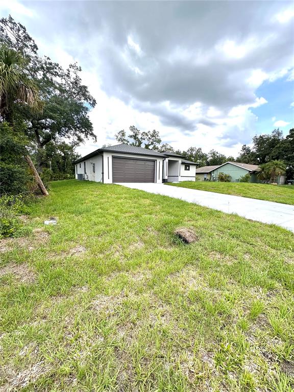 A single-story house with a brown garage door and a concrete driveway — 4653 SAN LUIS TERRACE, NORTH PORT, FL