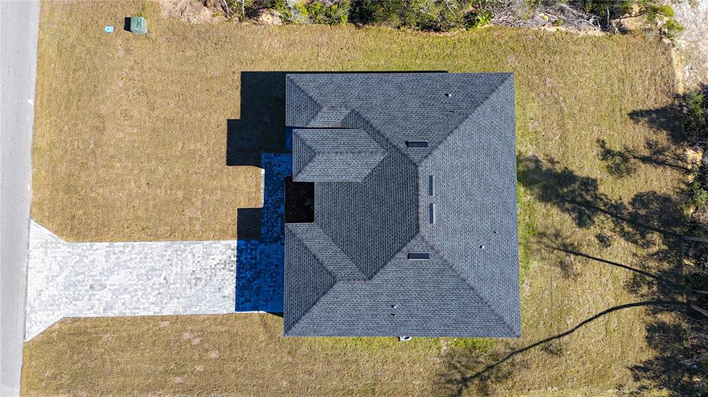 An aerial view shows a house with a dark shingled roof and a paved driveway — 2632 SW 162ND STREET ROAD, OCALA, FL