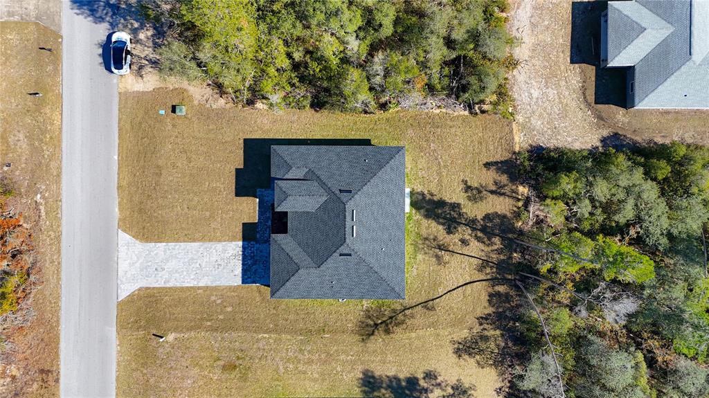 An aerial view shows a house with a dark shingled roof and a paved driveway — 2632 SW 162ND STREET ROAD, OCALA, FL