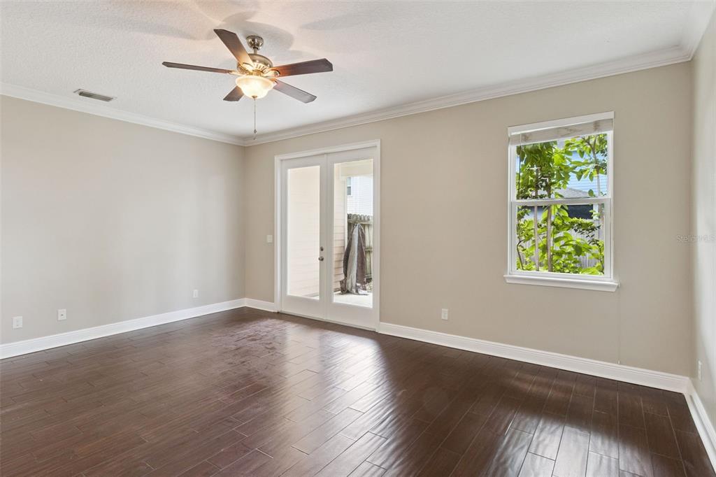 A kitchen features dark wood cabinets, granite countertops, stainless steel appliances, and a breakfast bar — 2544 MAYER STREET, ORLANDO, FL