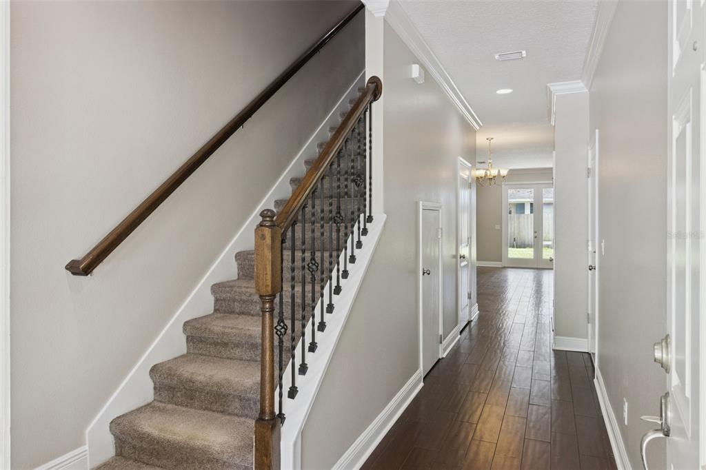 A kitchen with dark cabinets and a breakfast bar overlooks an open living area — 2544 MAYER STREET, ORLANDO, FL