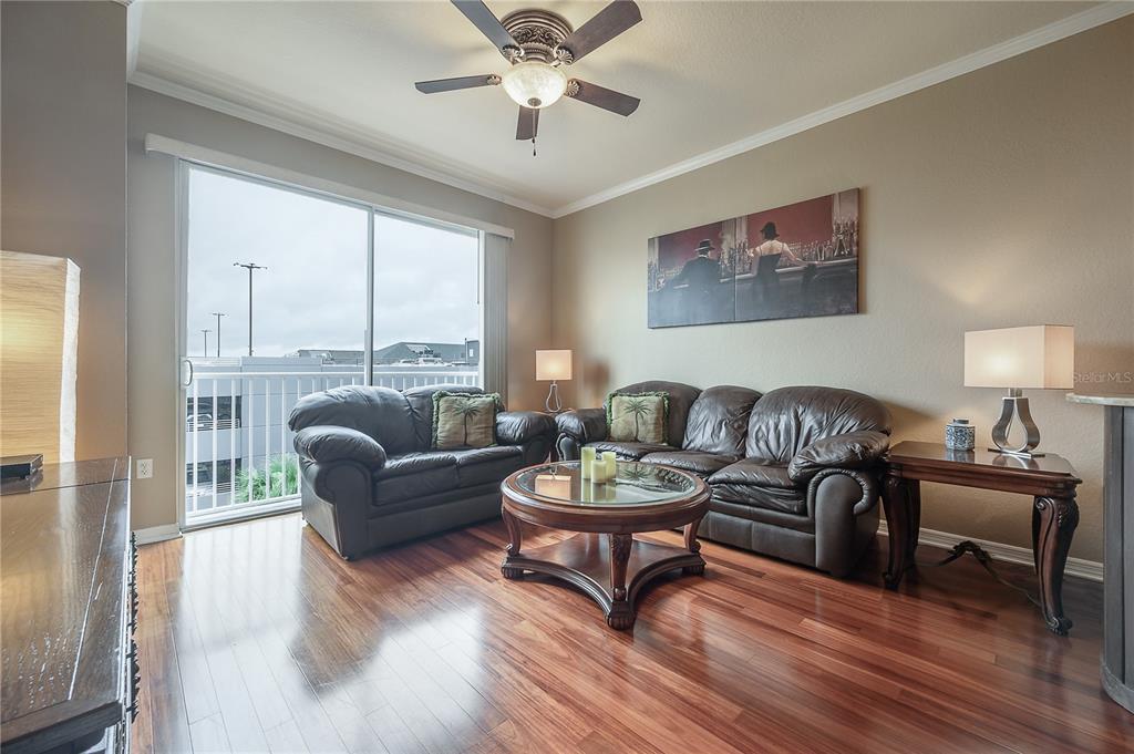 A living room features dark leather furniture, a glass coffee table, and hardwood flooring — 700 S HARBOUR ISLAND BOULEVARD UNIT 436, TAMPA, FL