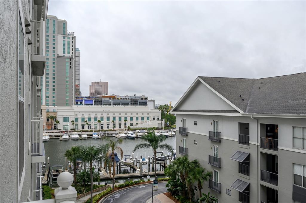 An elevated view of a marina with boats docked between a high-rise and apartment buildings — 700 S HARBOUR ISLAND BOULEVARD UNIT 436, TAMPA, FL