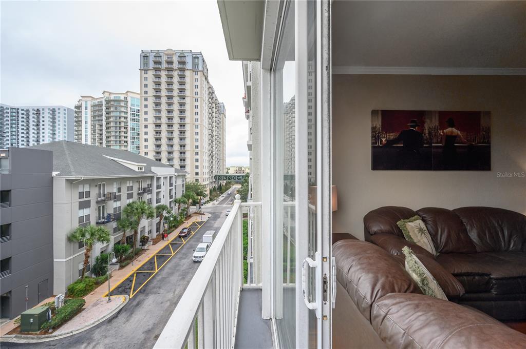 A balcony overlooks a street and tall buildings next to a living room with furniture — 700 S HARBOUR ISLAND BOULEVARD UNIT 436, TAMPA, FL