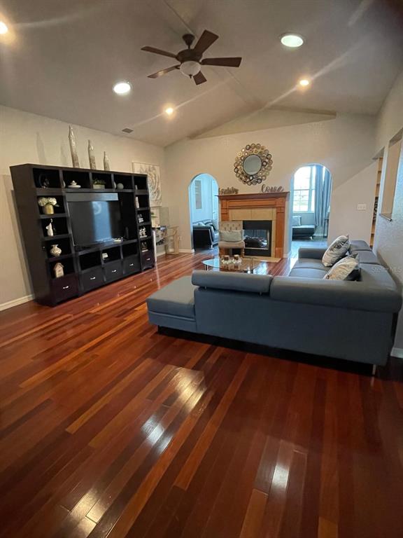 A living room features a large entertainment center, a sectional sofa, and hardwood flooring — 4005 CHELSEA LANE, LAKELAND, FL