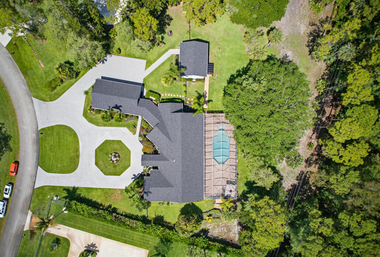 An aerial view shows a house with a pool enclosure, detached garage, and circular driveway — 14708 Stirrup Lane, Wellington FL 33414, WELLINGTON, FL