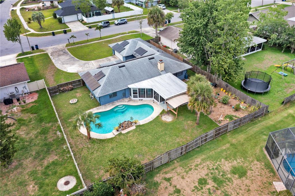 An aerial view shows a single-story house with a swimming pool and a fenced backyard — 969 GRAN PASEO DRIVE, ORLANDO, FL